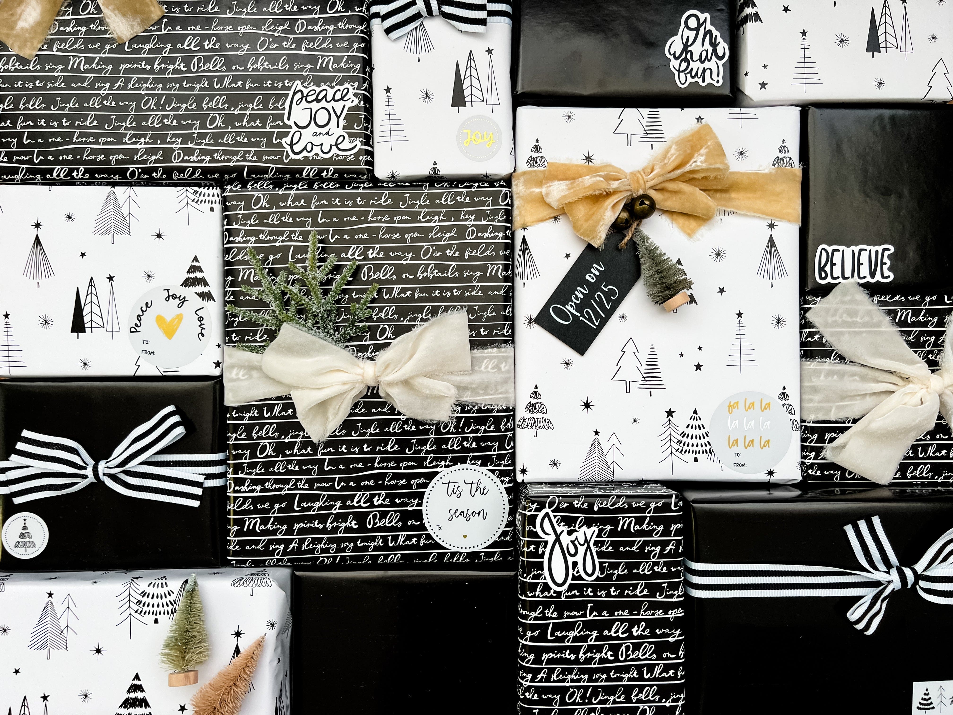 Collection of Christmas-themed gift boxes with bows and text on a black background