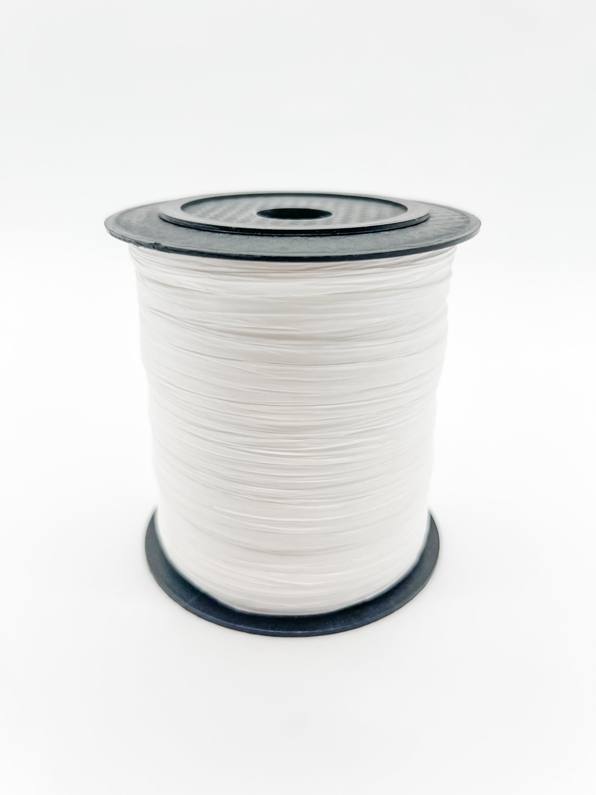 A spool of white paper raffia with a black plastic top and base, photographed on a clean white background.