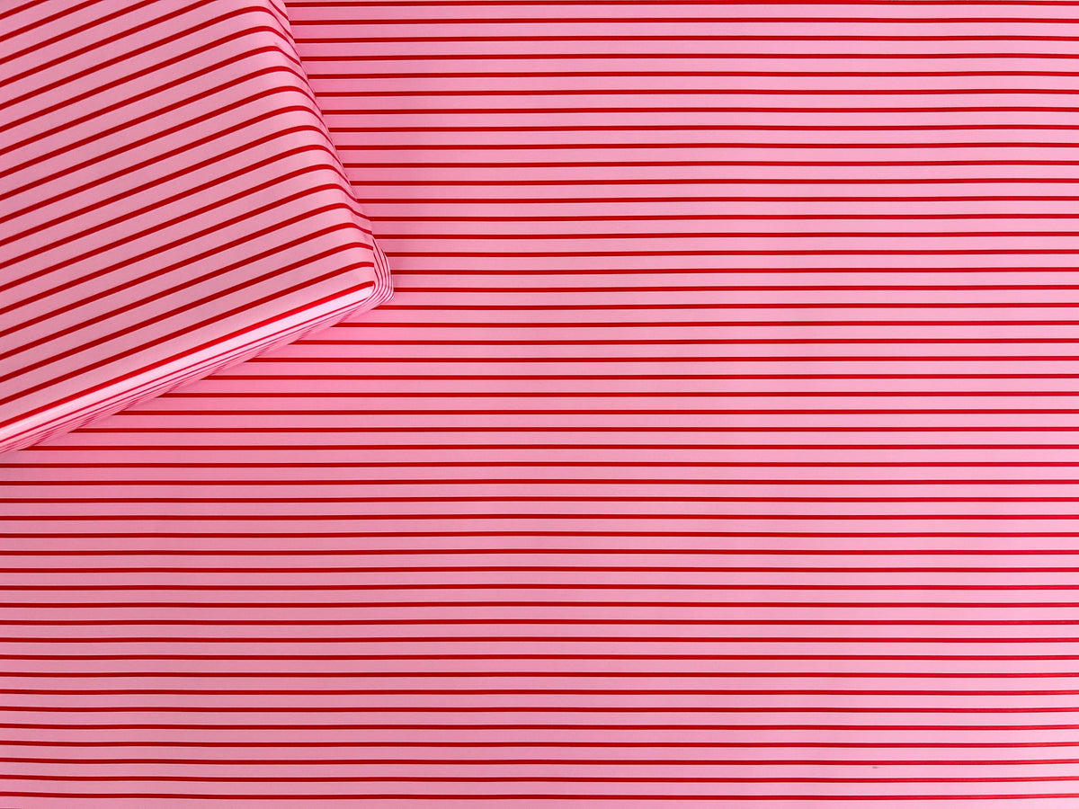 Close-up of pink wrapping paper with thin red stripes