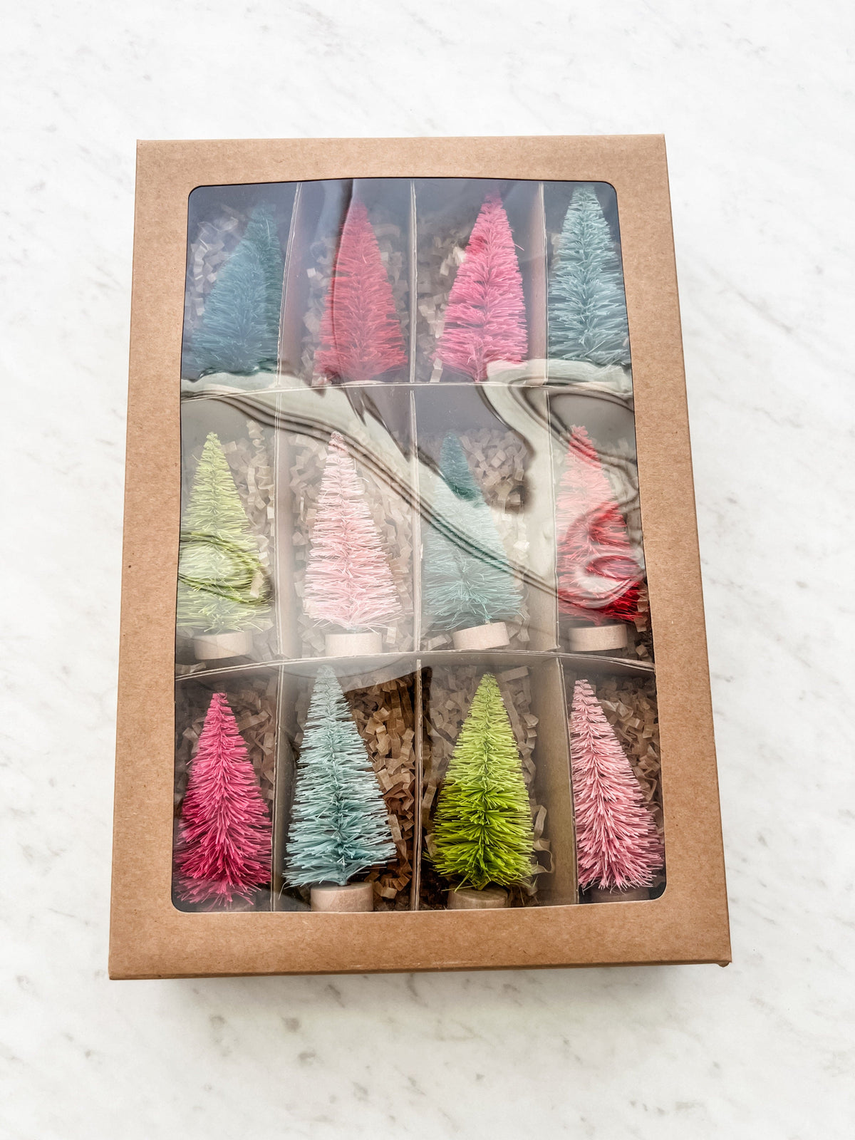 12 colorful trees shown packaged in a box