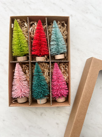 Set of 6 colorful bottle brush christmas trees shown in a box