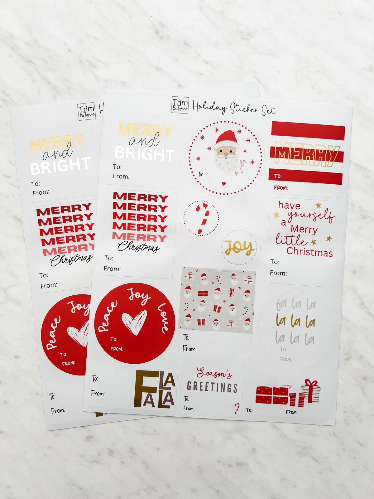 Two sheets of Christmas-themed stickers with various designs including Santa Claus, Christmas trees, and holiday greetings in red, white, gold, and silver colors.