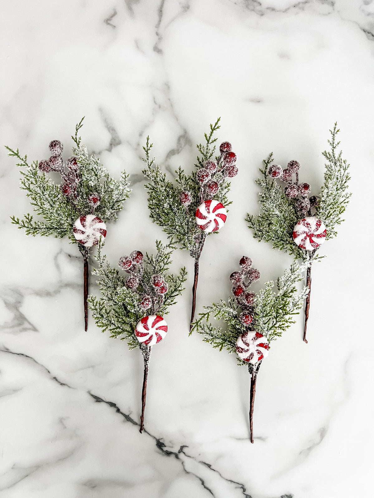 Decorative sticks with peppermint designs on a marble surface