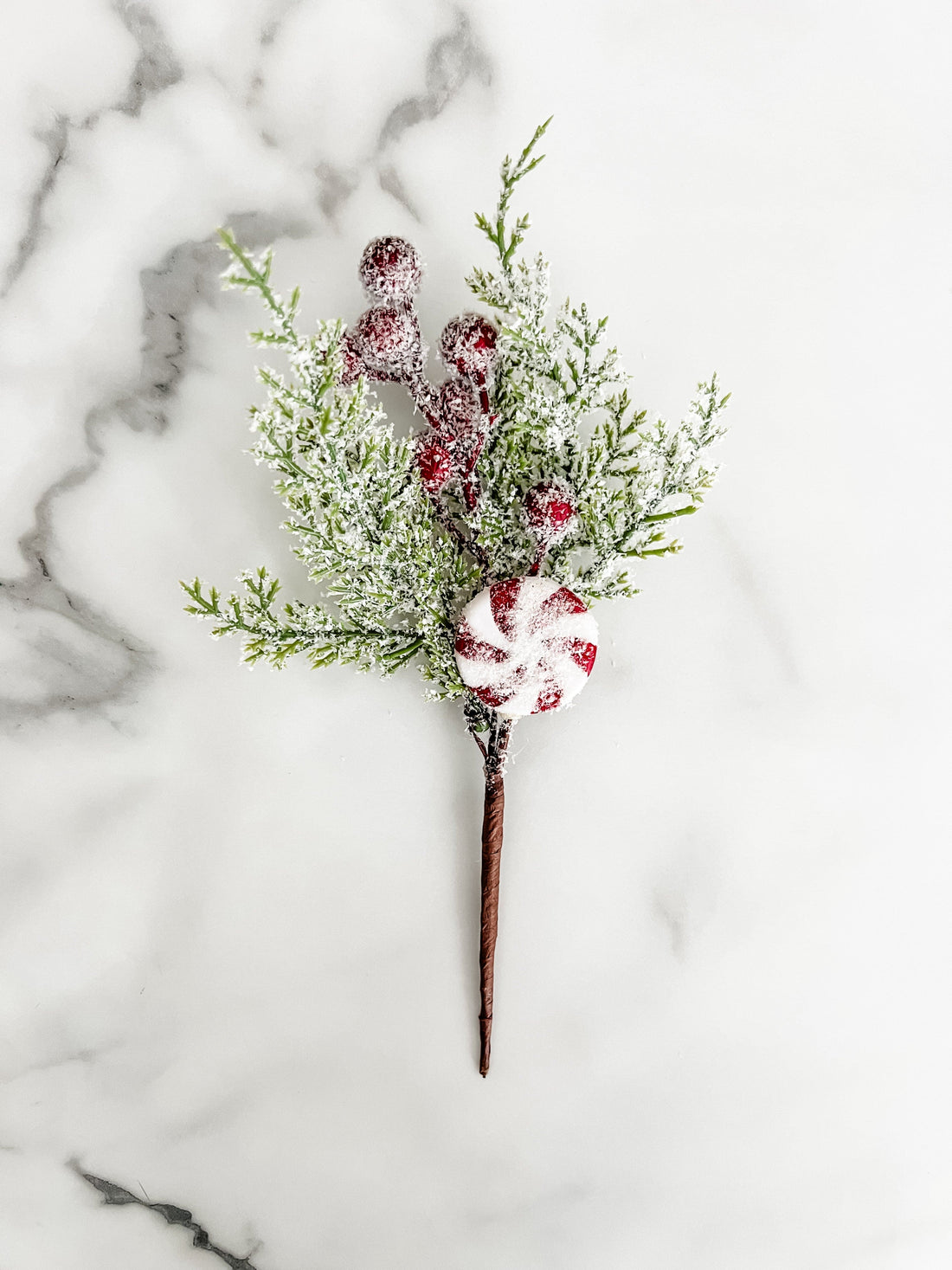 Decorative sticks with peppermint designs on a marble surface