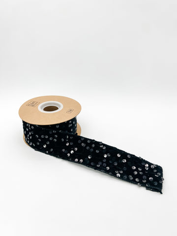 Black sequin velvet ribbon against a white background