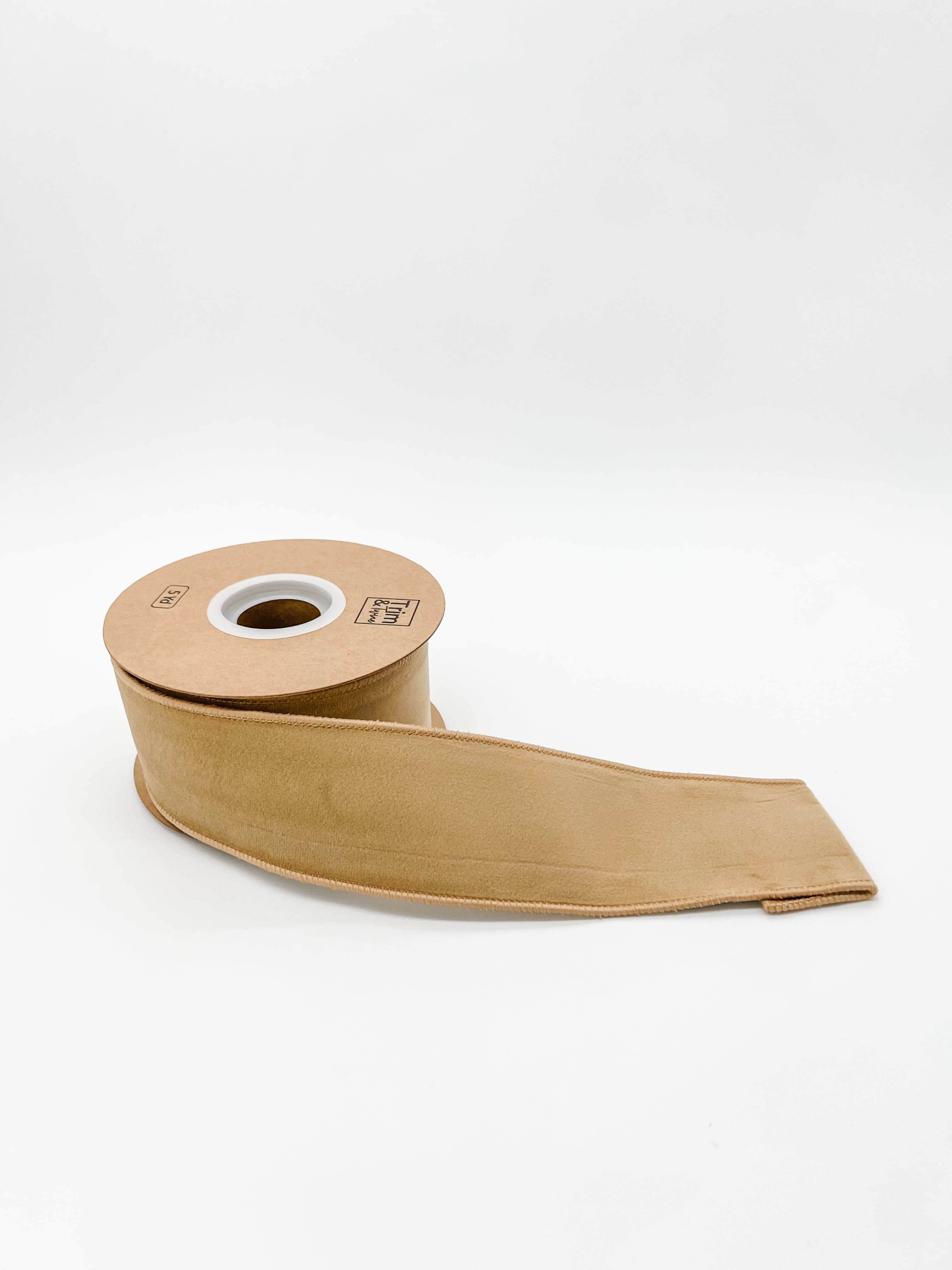 Gold velvet ribbon roll on a white background