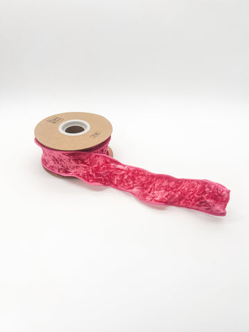 Roll of pink ribbon on a white background
