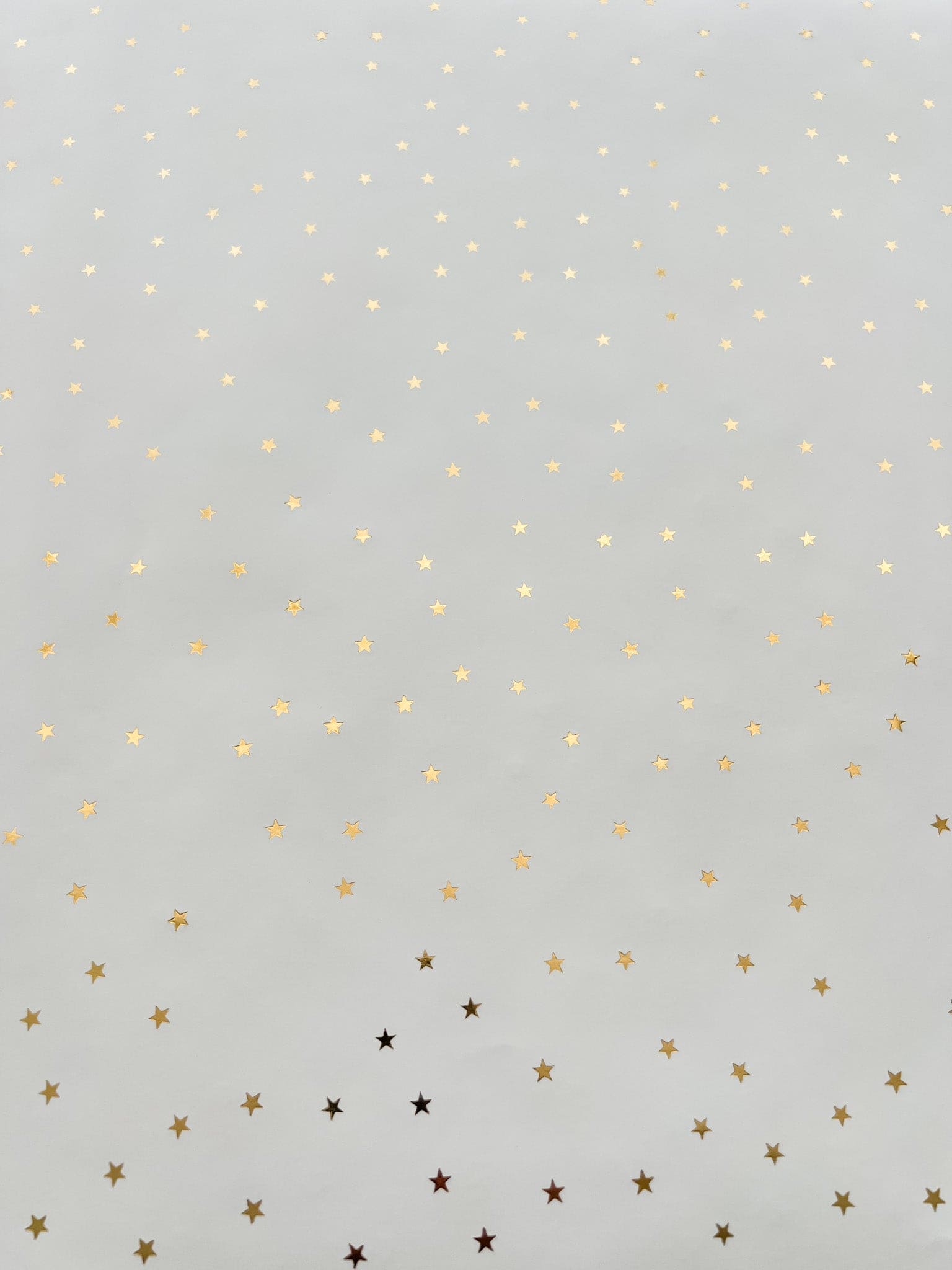 Flat lay of gold metallic star wrapping paper