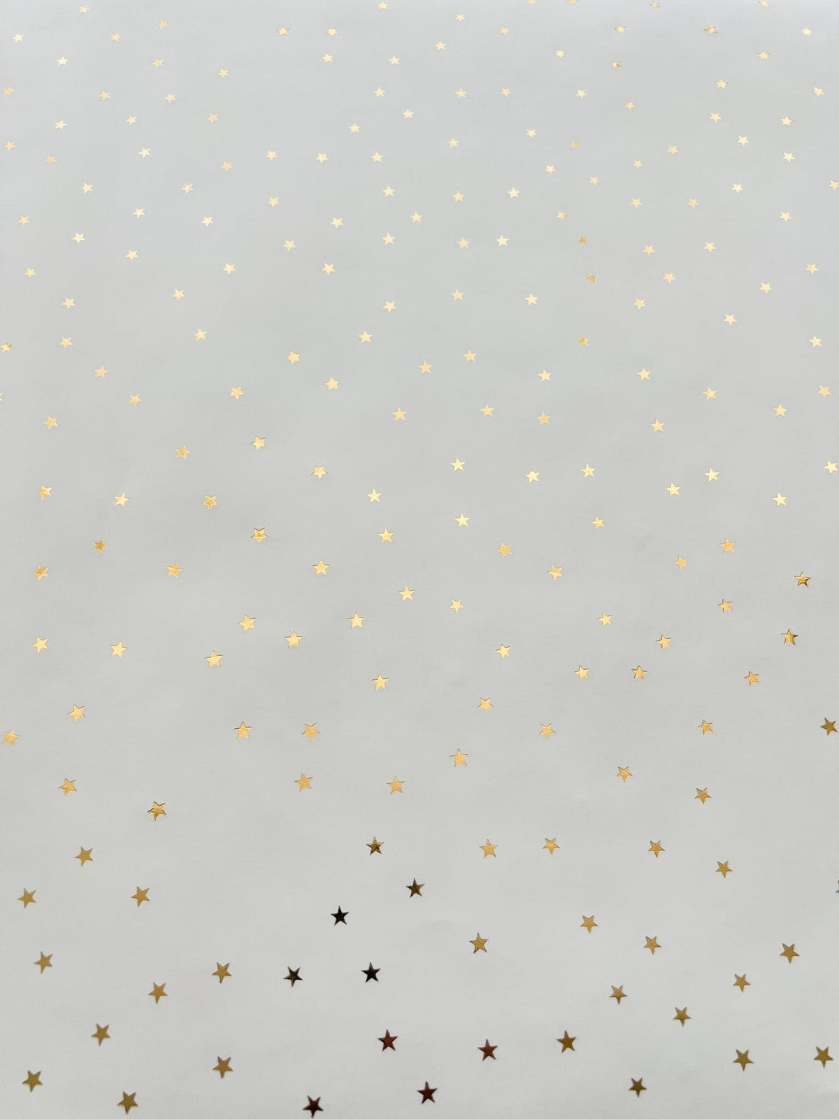 Flat lay of gold metallic star wrapping paper