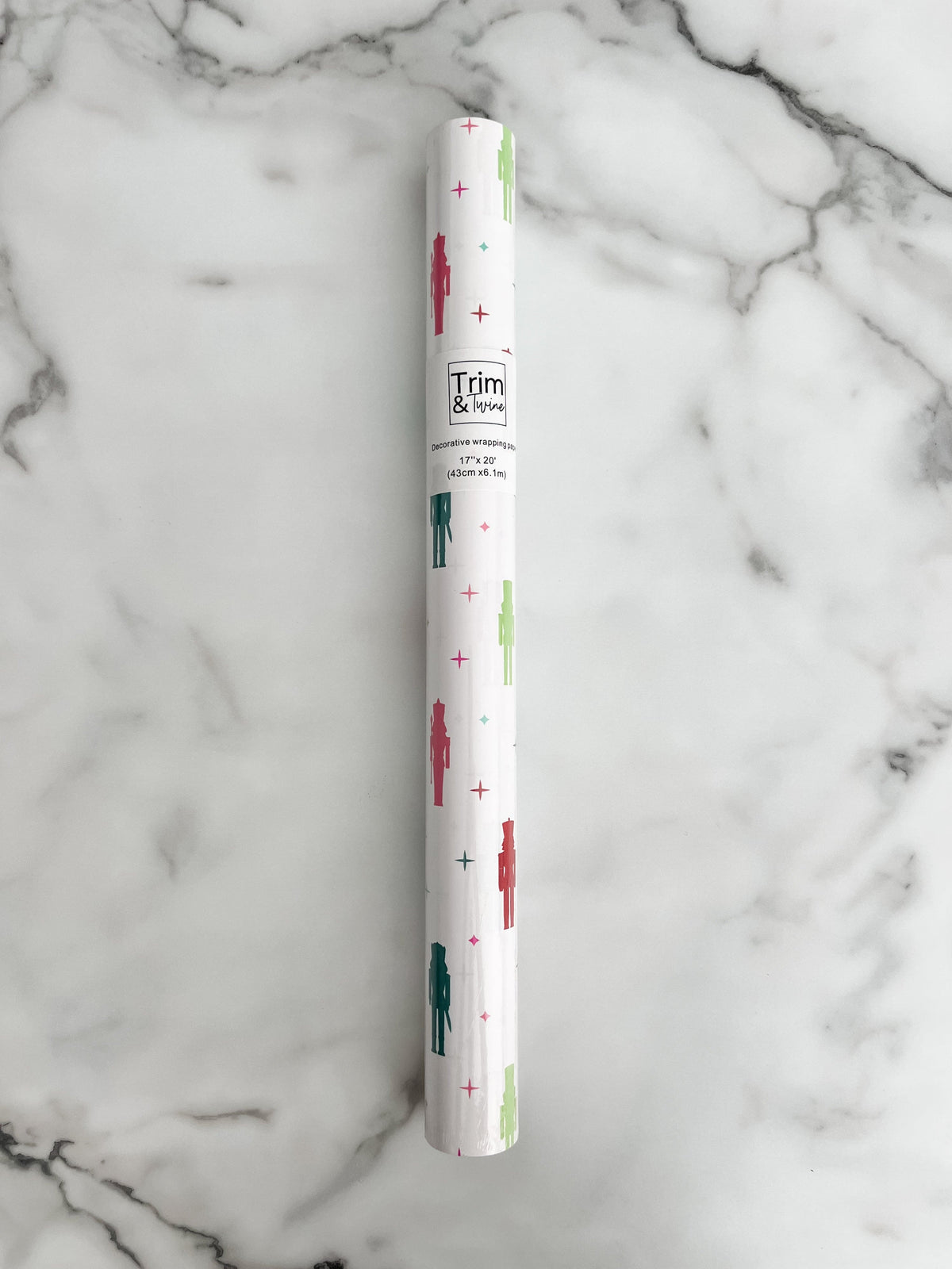 Wrapping paper roll with a white background and colorful nutcrackers on it
