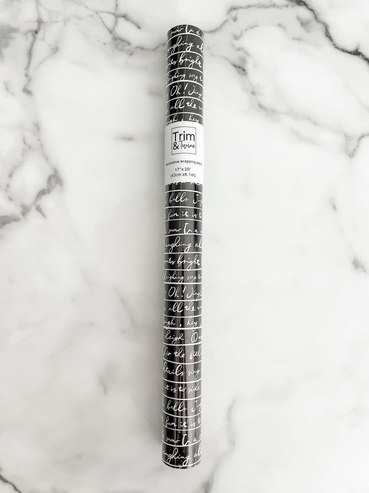 Roll of black wrapping paper with white script letters