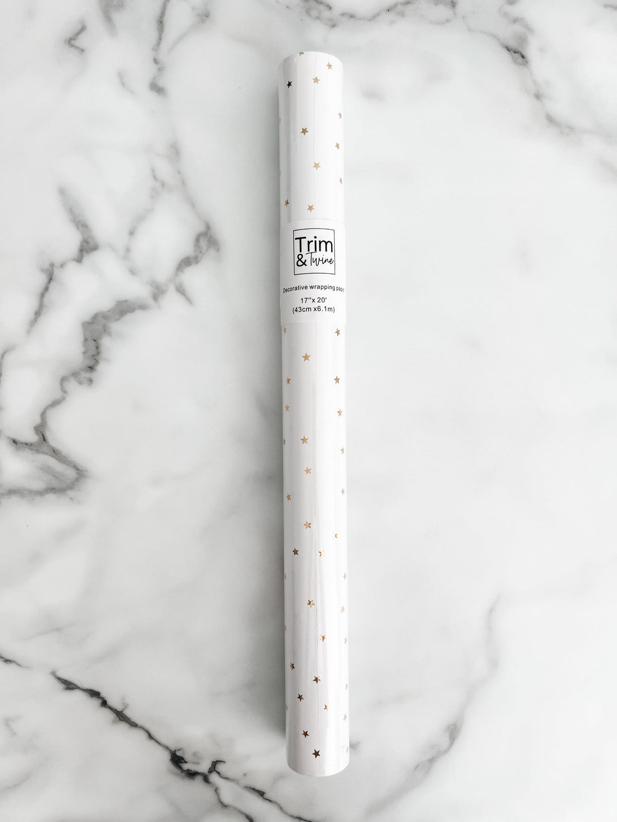 Roll of white paper with gold metallic stars on it
