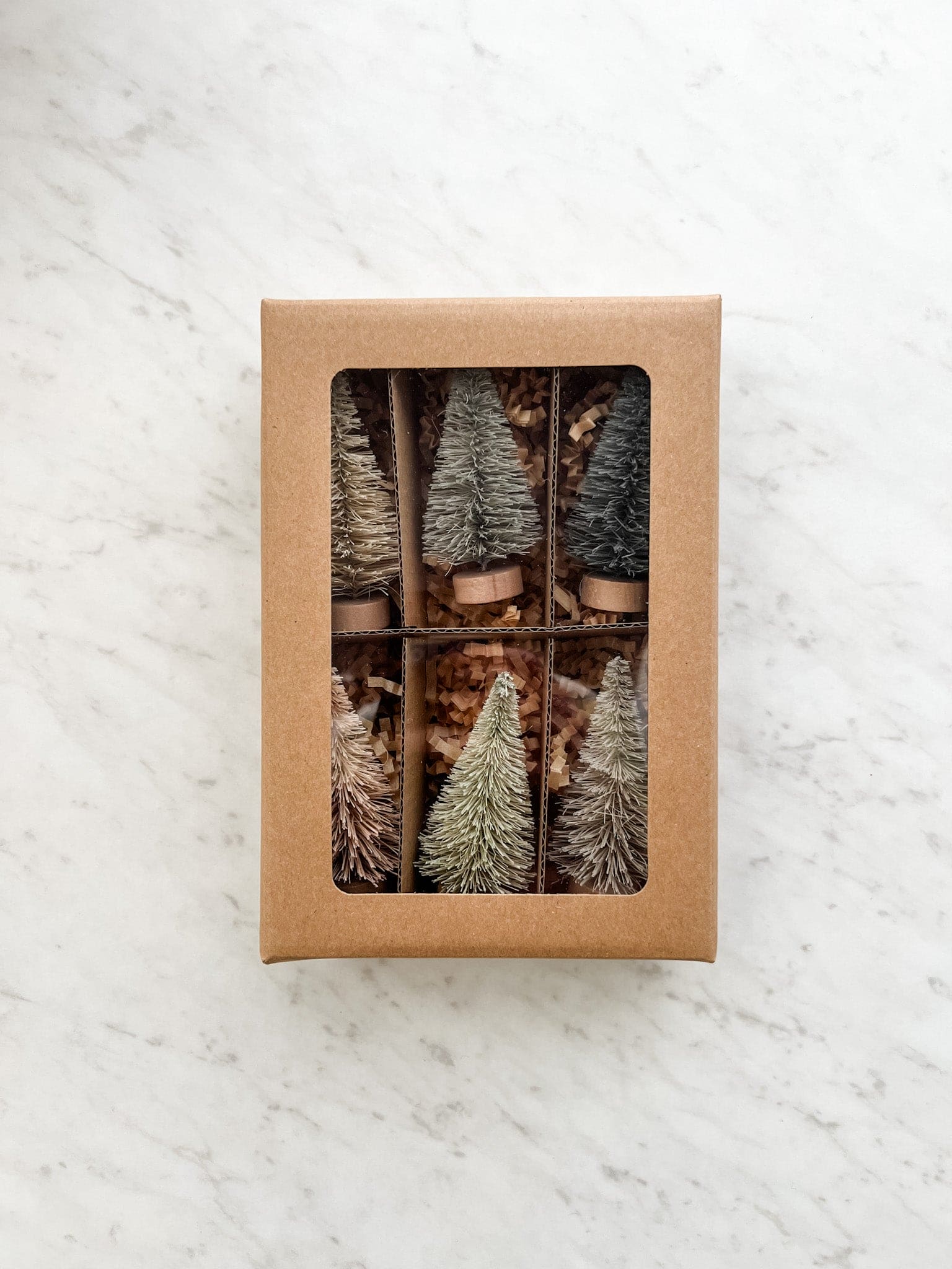 Set of 6 neutral colored bottle brush trees shown packaged in a box