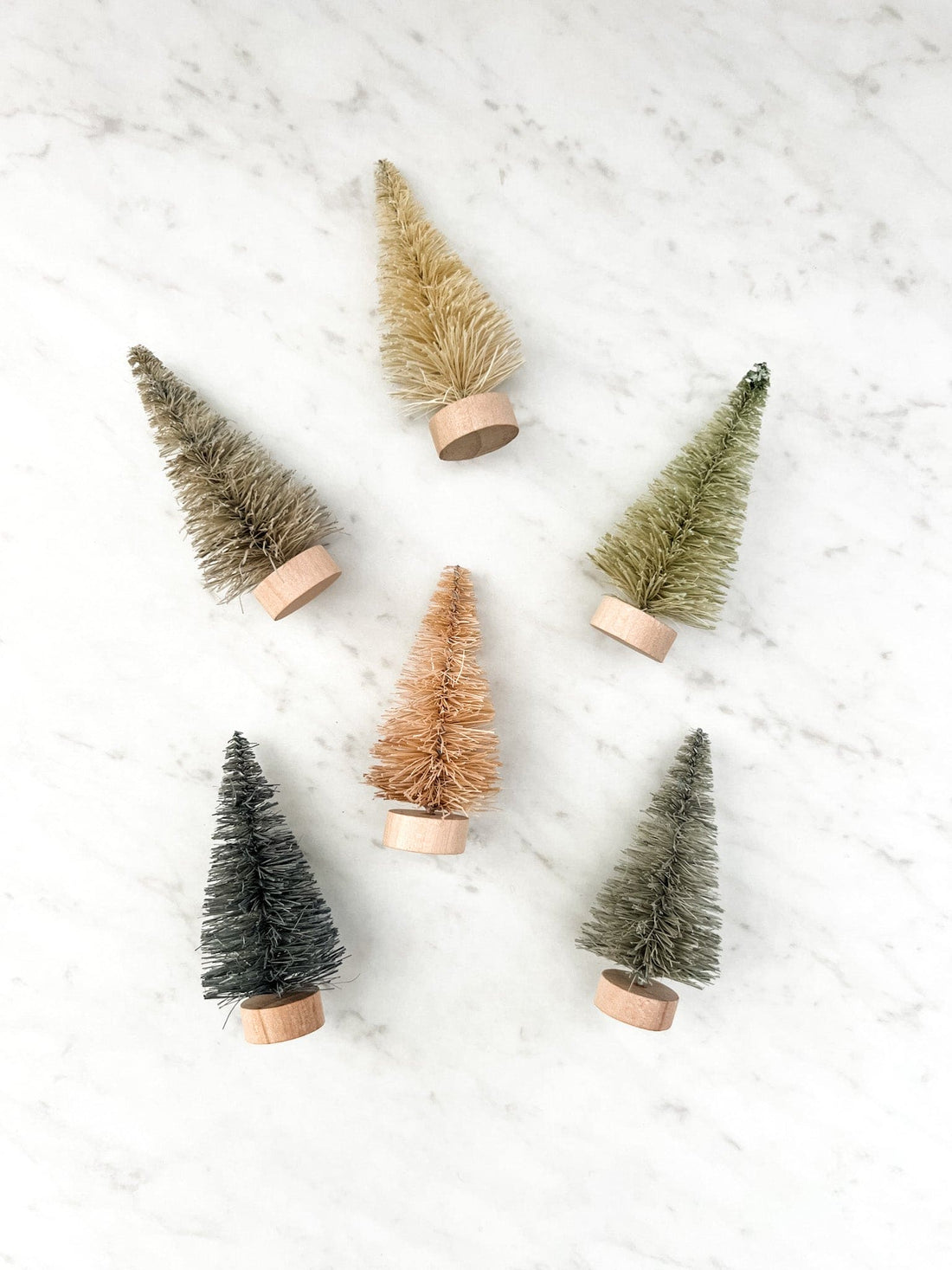 Set of 6 bottle brush trees in a cardboard box, with trees being different colors.