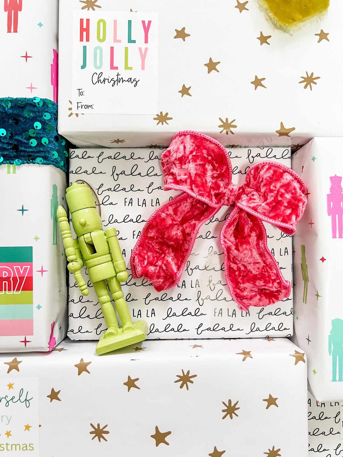 Gift box with a pink bow, green toy soldier, and colorful text on a festive background.