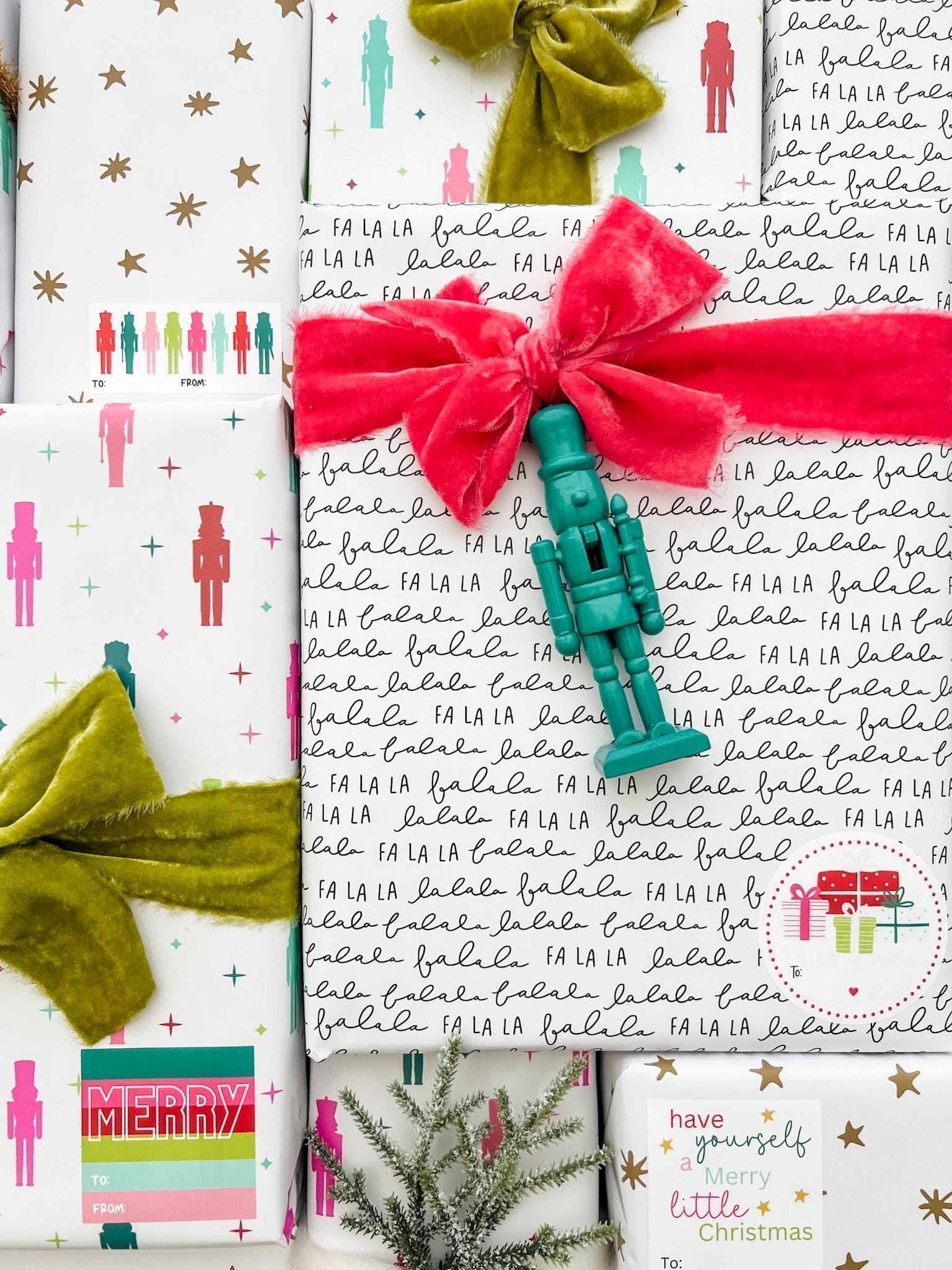 Colorful Christmas-themed gift wrap with ribbons and text on a white background