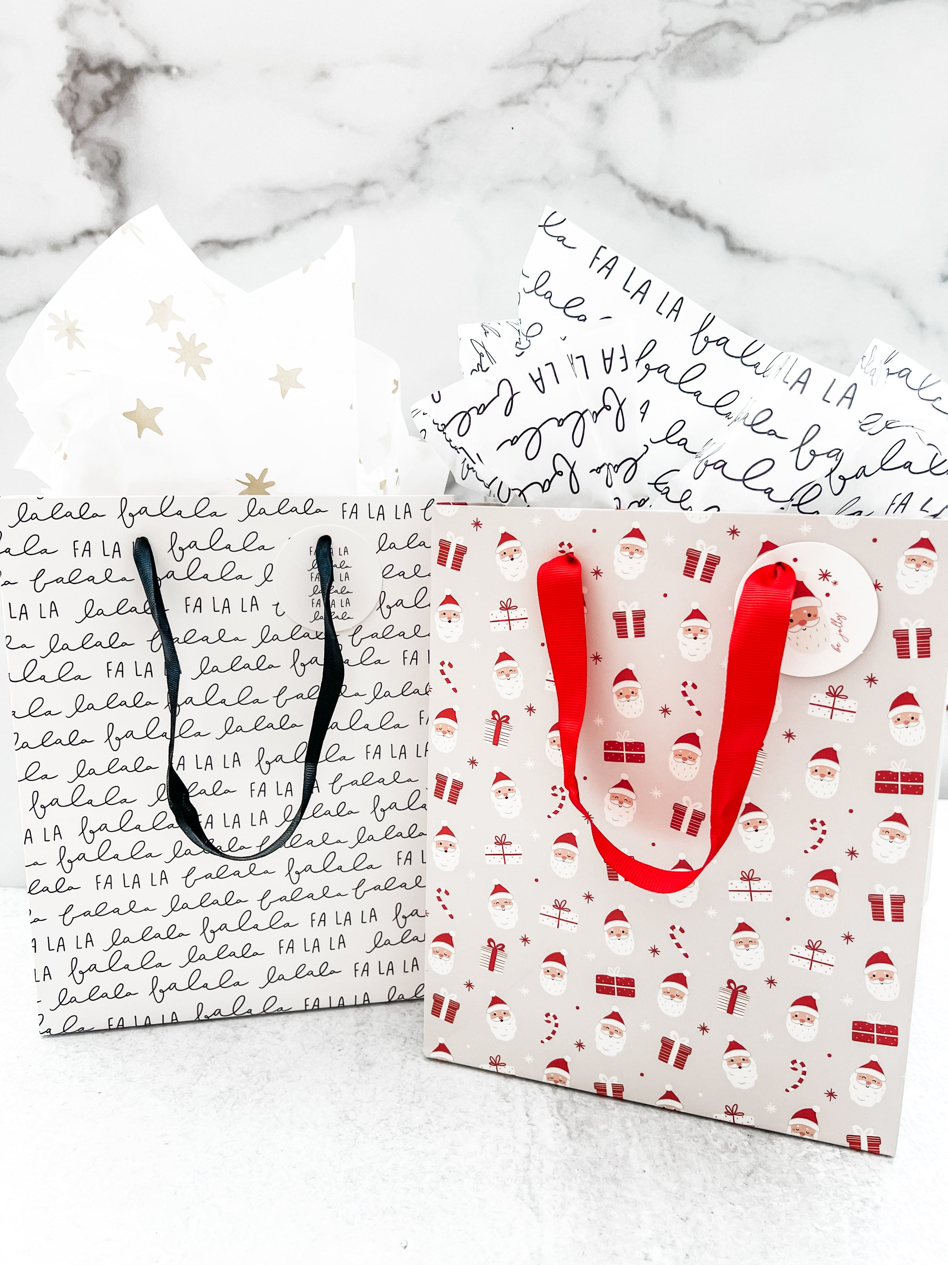 Two gift bags shown, one fa la la design and one santa design.