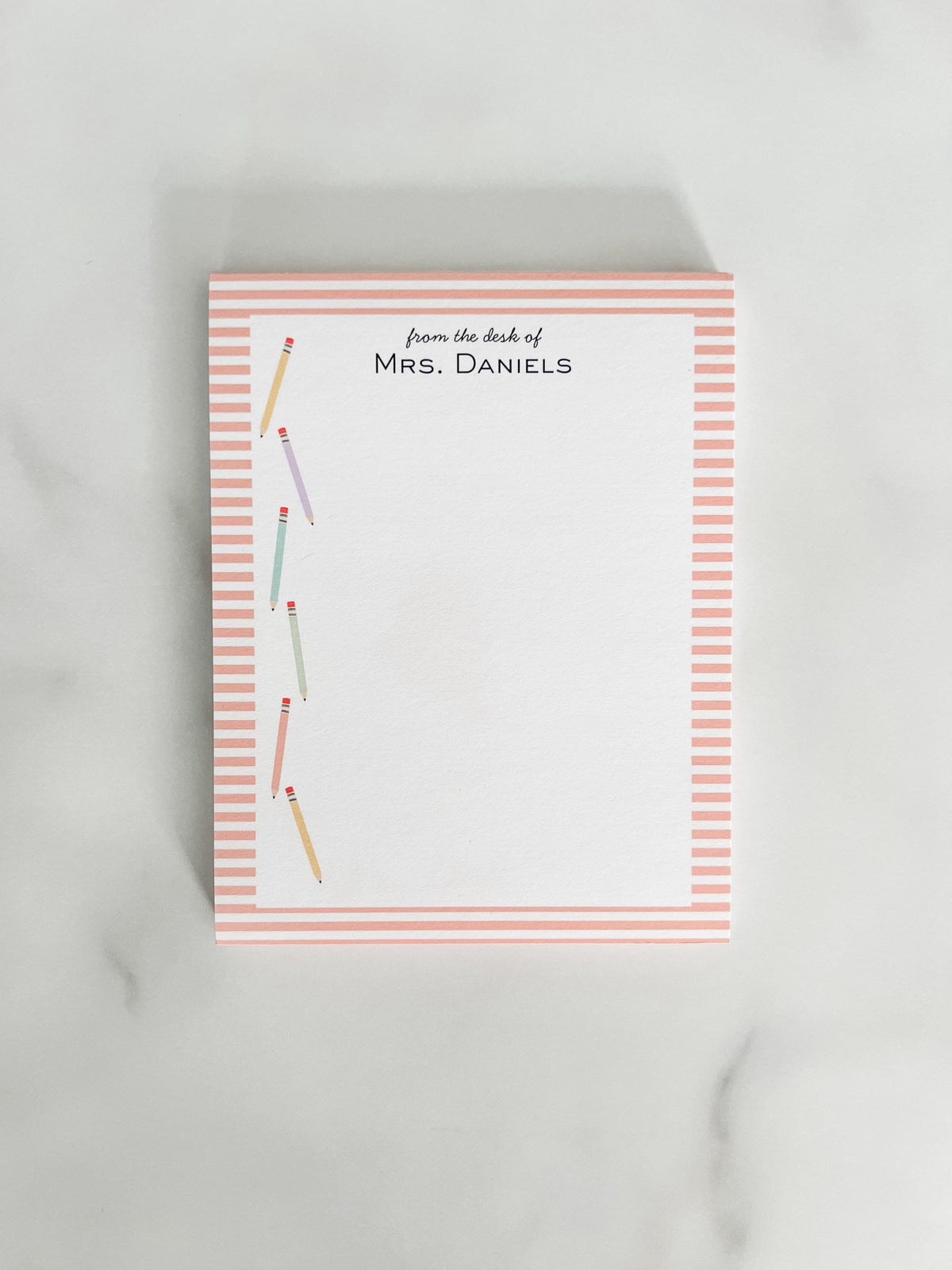 Personalized teacher notepad with colorful pencils and a striped edge.
