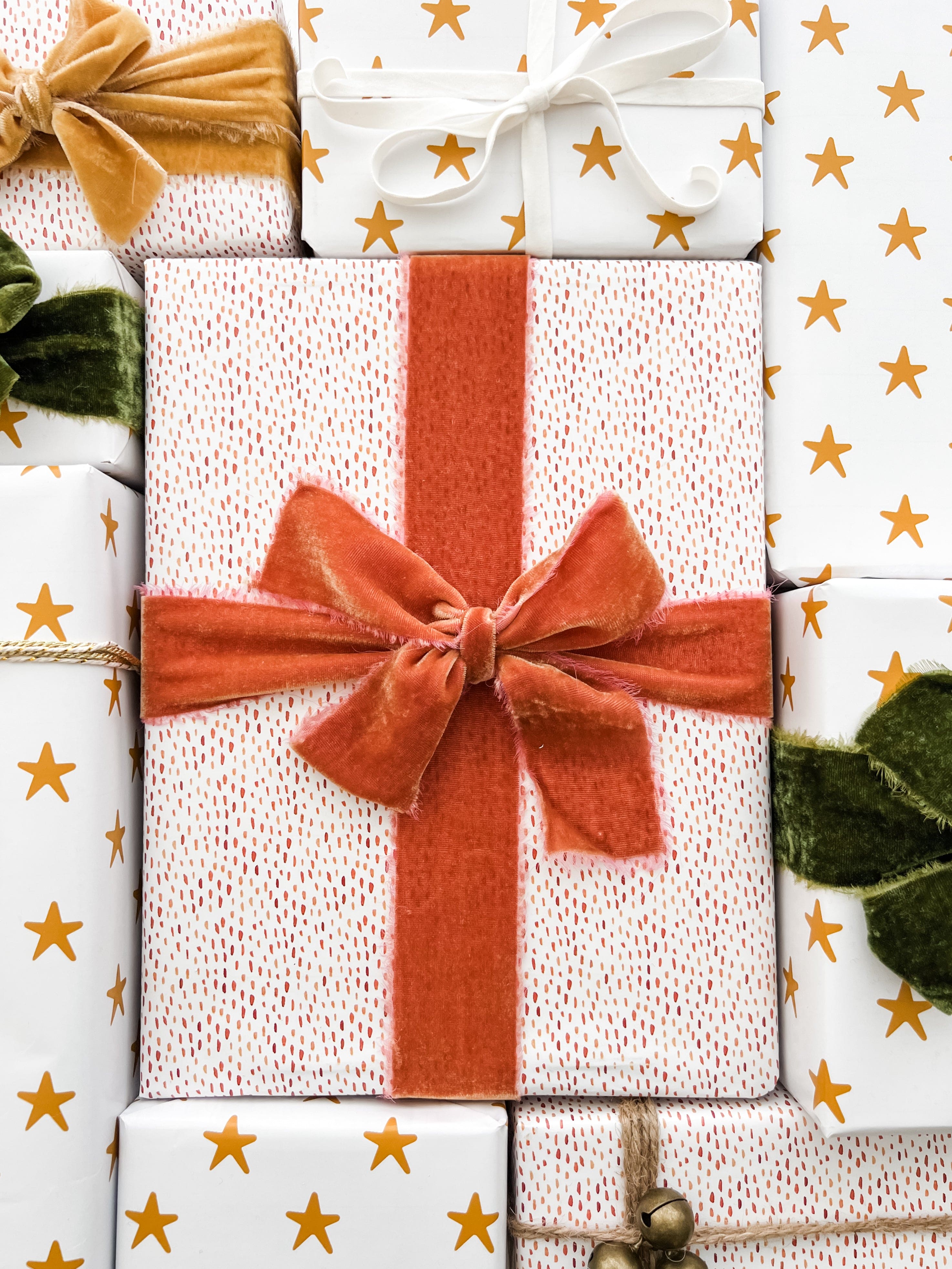 Flat lay of gold wrapping papers with velvet ribbon